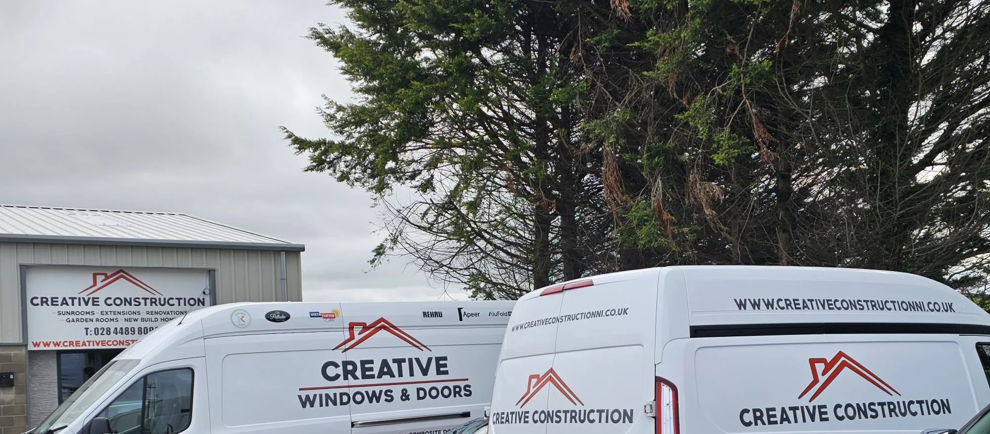 Creative Construction branded vans outside the company premises in Downpatrick