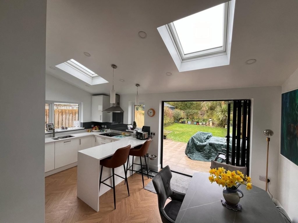 Rooflights above the kitchen and dining area with bifold doors folded back