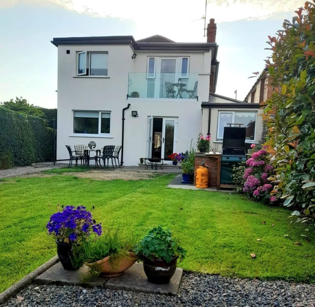 Rear view of the house with a new first floor balcony and bedroom extension