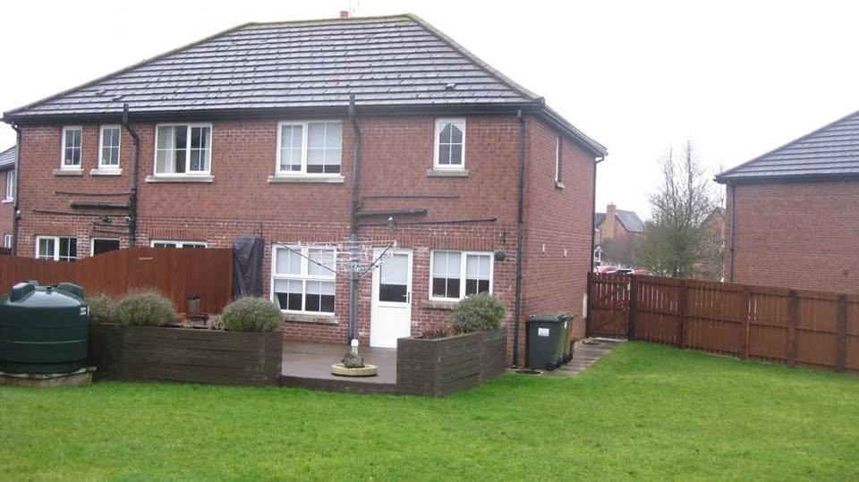 Rear of the original two storey red brick house before the extension
