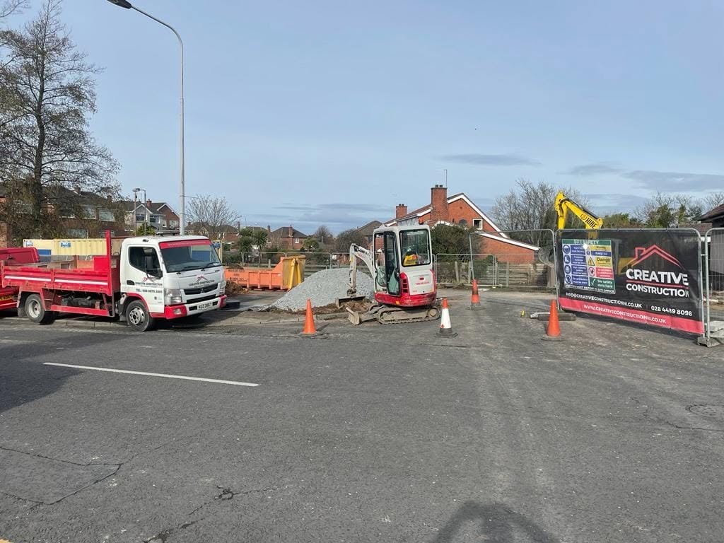 Groundworks beside the surgery with a digger, truck and construction banner