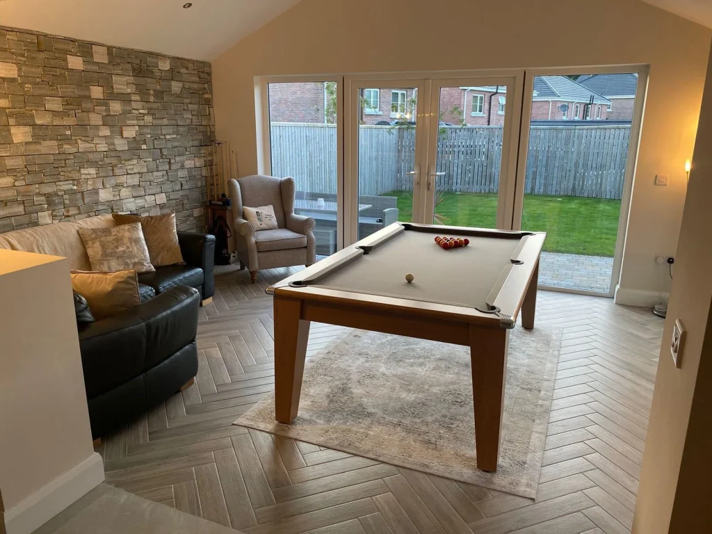 Completed room with stone feature wall and garden doors