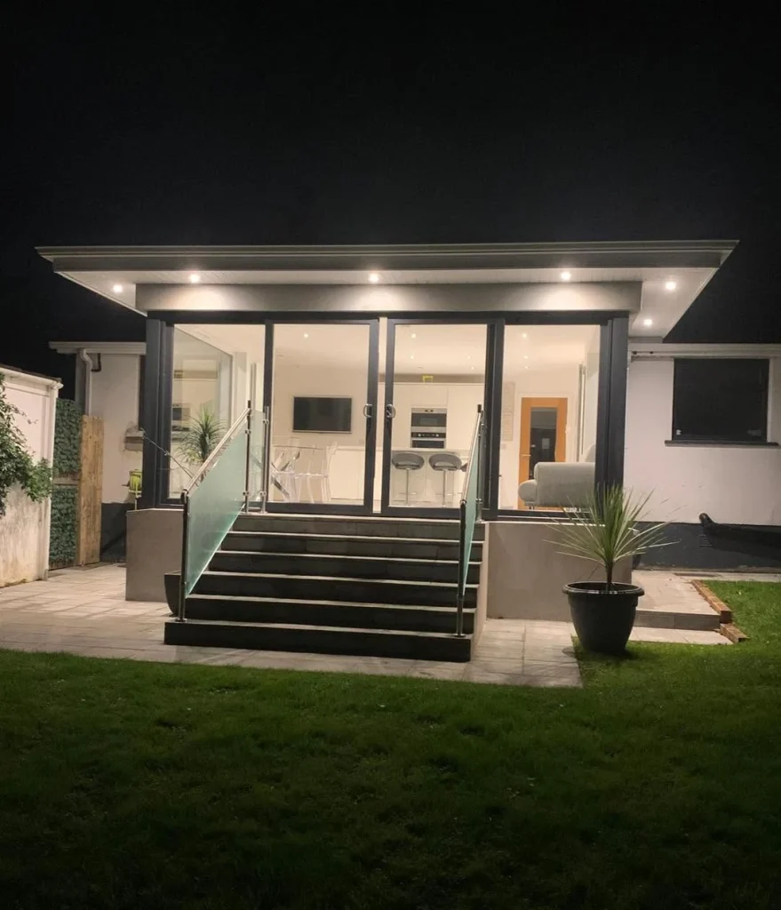 Illuminated rear extension viewed from the garden at night