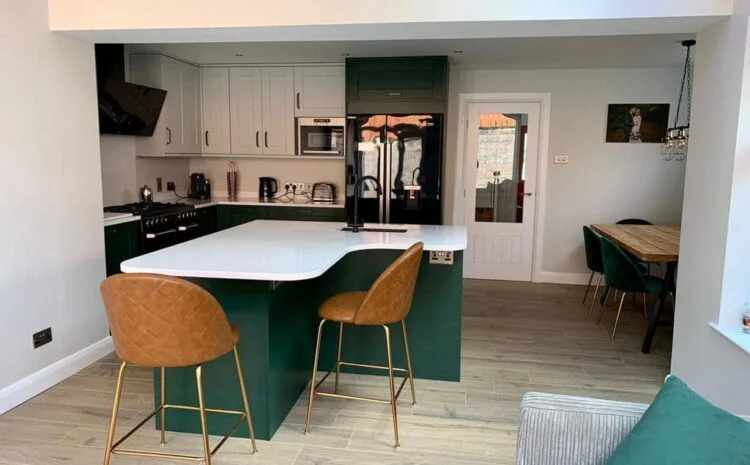 A completed green and white kitchen with a curved island