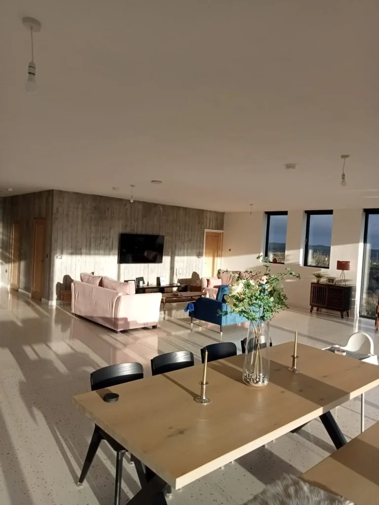 Dining and living area with broad windows